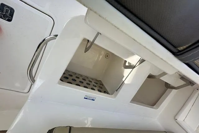 Slide: The Image of 2019 Pursuit DC 365 Dual Console boat storage compartments and seating area. - 17