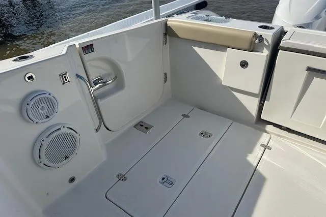 Slide: The Image of 2019 Pursuit DC 365 Dual Console boat interior with speakers and storage compartments. - 22