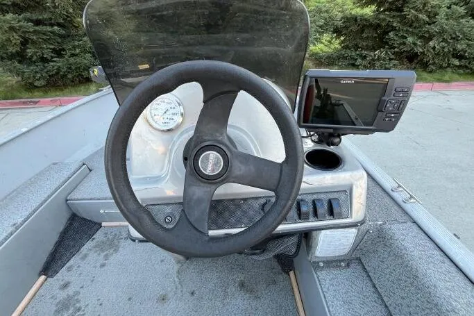 Slide: The Image of 2008 Tracker Super Guide V-14 SC boat dashboard with steering wheel and Garmin device. - 11
