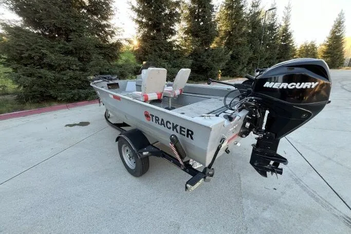 Slide: The Image of 2008 Tracker Super Guide V-14 SC boat with Mercury outboard motor on a trailer. - 18