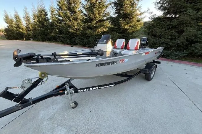 Slide: The Image of 2008 Tracker Super Guide V-14 SC fishing boat on trailer, parked outdoors. - 3