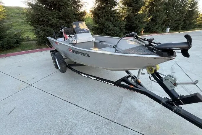 Slide: The Image of 2008 Tracker Super Guide V-14 SC boat on trailer, parked outdoors. - 4