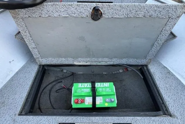 Slide: The Image of 2008 Tracker Super Guide V-14 SC boat battery compartment with green Interstate battery. - 8