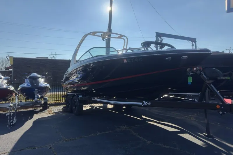 Slide: The Image of 2016 Chaparral 227 SSX boat on trailer, parked outdoors in sunlight. - 2