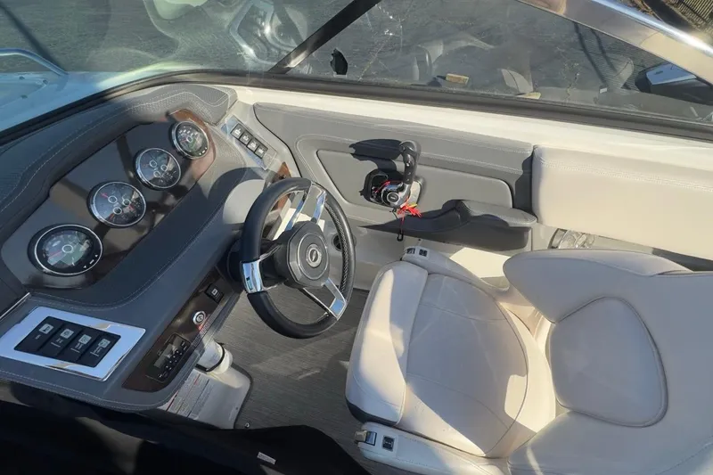 Slide: The Image of Interior view of 2016 Chaparral 227 SSX boat cockpit with steering wheel and gauges. - 7