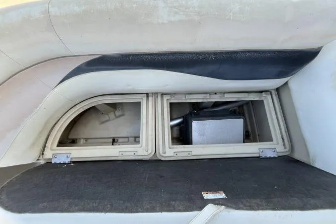 Slide: The Image of Storage compartment in a 2013 Godfry Sweetwater boat, featuring dual access panels. - 10