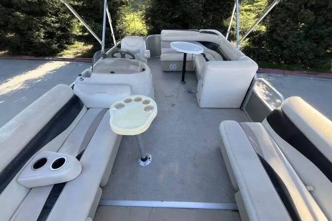 Slide: The Image of 2013 Godfry Sweetwater pontoon boat interior with seating and tables. - 11