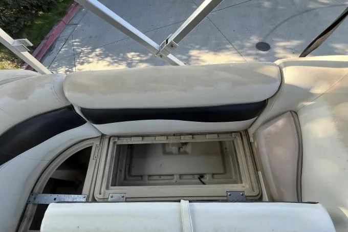 Slide: The Image of Open storage compartment on a 2013 Godfry Sweetwater boat seat. - 13
