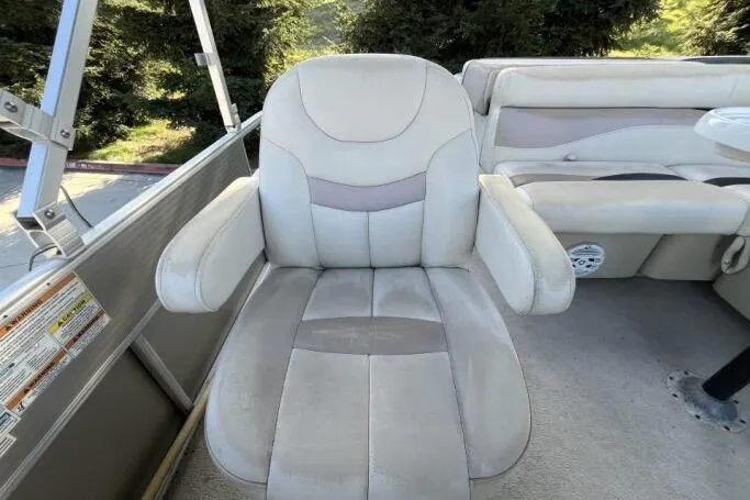 Slide: The Image of 2013 Godfry Sweetwater boat seat with beige upholstery and armrests. - 16