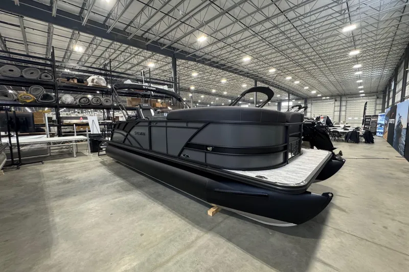 The Image of 2026 Sylvan Mirage X X3 CLZ pontoon boat in a spacious warehouse setting. - 1