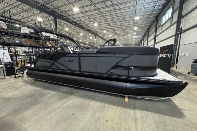 Slide: The Image of 2026 Sylvan Mirage X X3 CLZ pontoon boat in a spacious indoor showroom. - 3