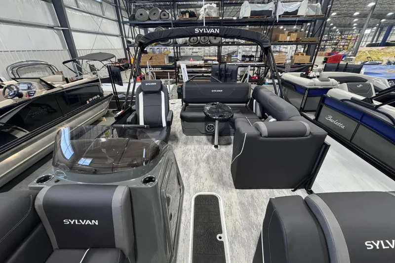 Slide: The Image of 2026 Sylvan Mirage X X3 CLZ pontoon boat interior in showroom setting. - 7