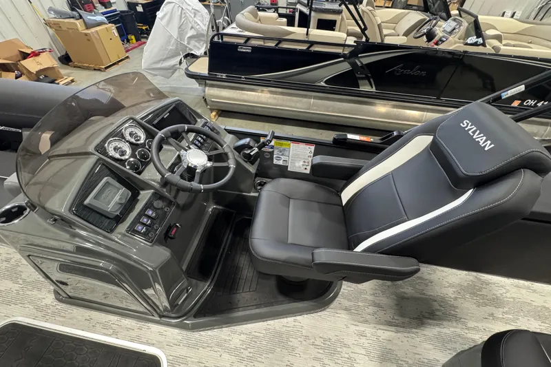 Slide: The Image of Captain's seat and dashboard of 2026 Sylvan Mirage X X3 CLZ boat in showroom. - 8