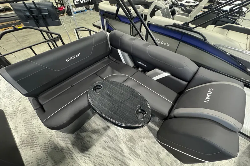 Slide: The Image of 2026 Sylvan Mirage X X3 CLZ boat interior with sleek seating and a central table. - 9