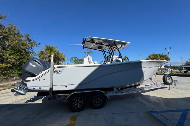 Slide: The Image of 2022 Sea Fox 288 Commander boat on trailer, featuring Yamaha engine, under clear blue sky. - 10