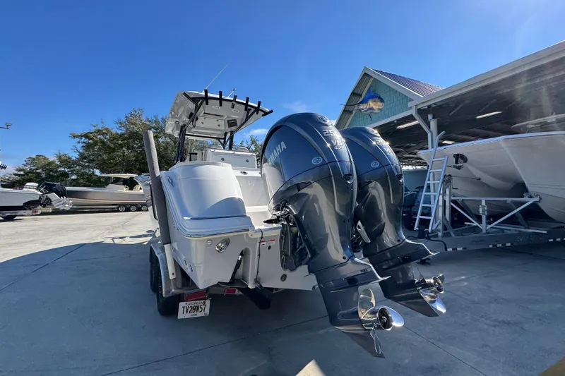 Slide: The Image of 2022 Sea Fox 288 Commander boat with dual Yamaha engines in a marina setting. - 14