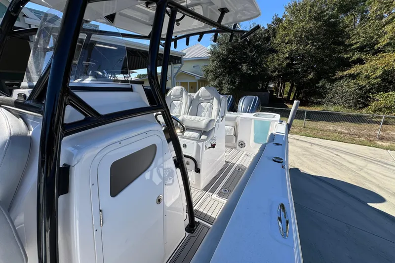 Slide: The Image of 2022 Sea Fox 288 Commander boat interior with seating and console, parked outdoors. - 23