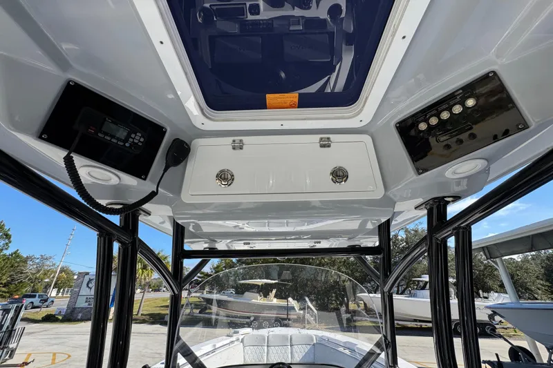 Slide: The Image of 2022 Sea Fox 288 Commander boat interior with control panel and overhead storage. - 34