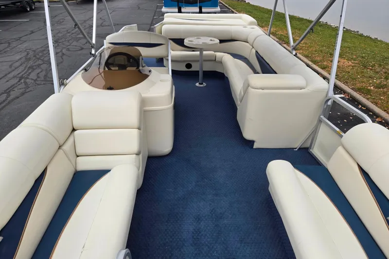 Slide: The Image of 2005 Odyssey 522C pontoon boat interior with white seating and blue carpet. - 10