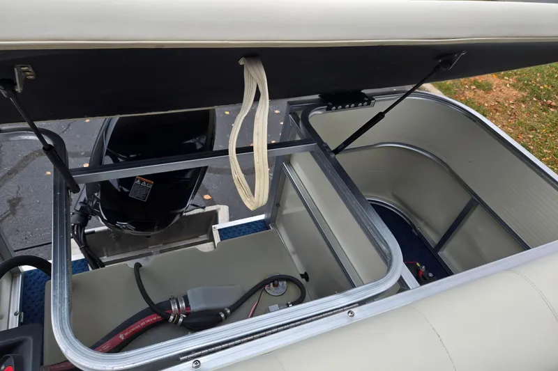 Slide: The Image of 2005 Odyssey 522C boat storage compartment with open lid and visible engine. - 15