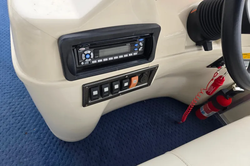 Slide: The Image of Control panel of a 2005 Odyssey 522C boat with radio and switches. - 4