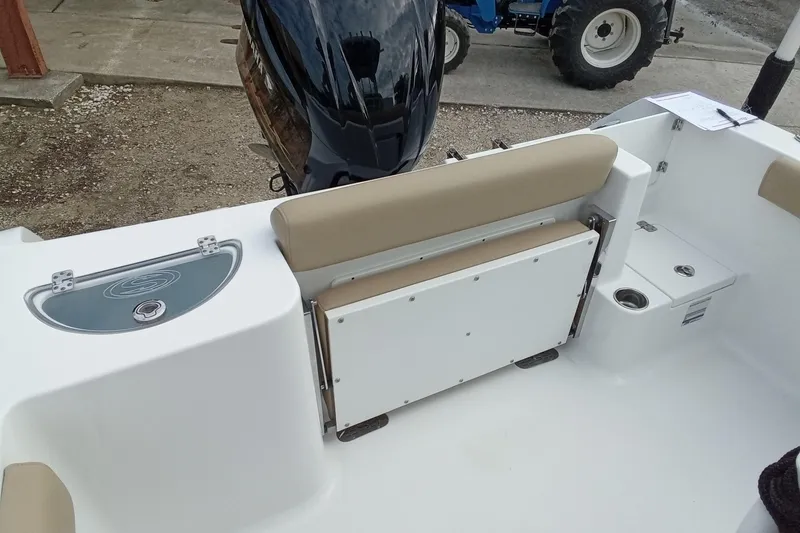 Slide: The Image of 2018 Sportsman Open 232 Center Console boat interior with seating and storage compartments. - 10