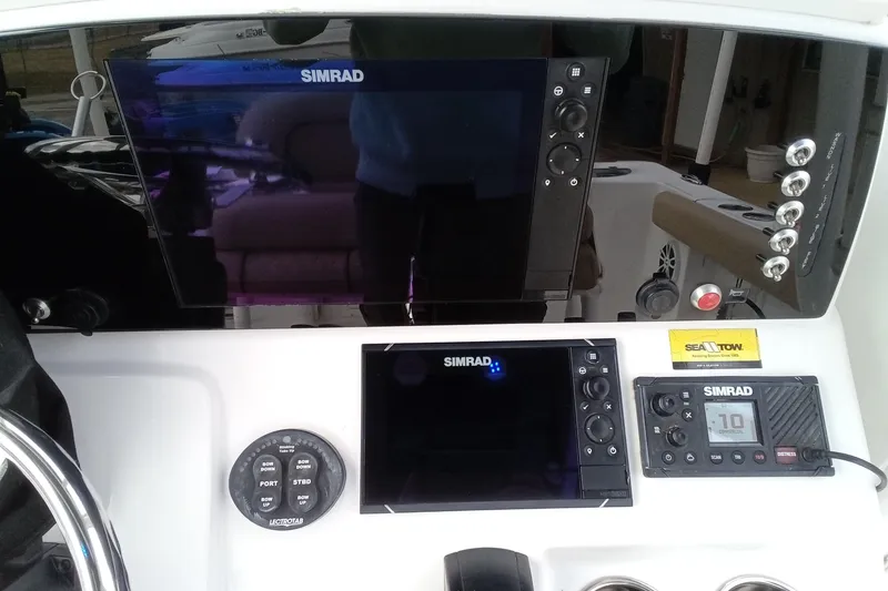 Slide: The Image of 2018 Sportsman Open 232 Center Console dashboard with Simrad electronics and controls. - 14