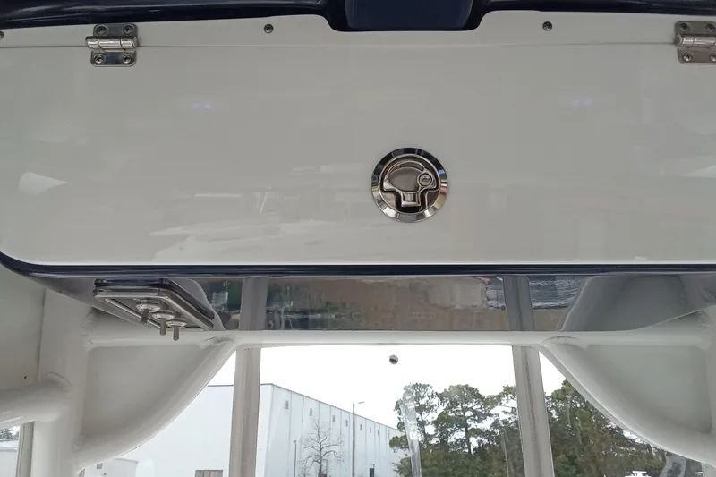 Slide: The Image of 2018 Sportsman Open 232 Center Console boat interior, featuring a sleek storage compartment. - 15