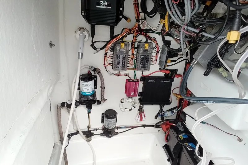 Slide: The Image of 2018 Sportsman Open 232 Center Console wiring and components in boat compartment. - 24