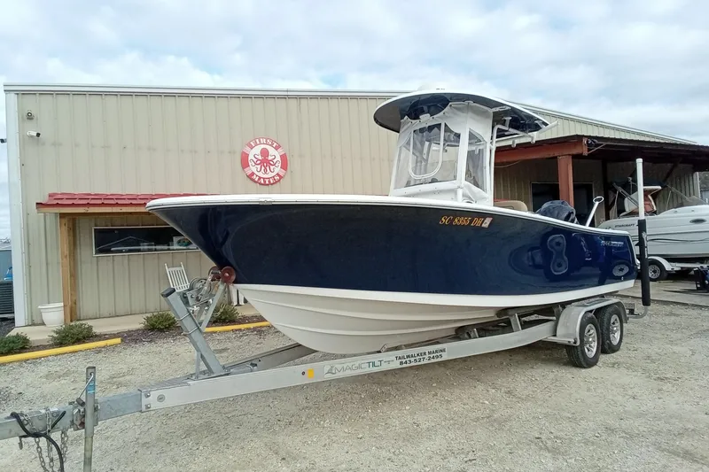 Slide: The Image of 2018 Sportsman Open 232 Center Console boat on trailer outside a marine shop. - 3