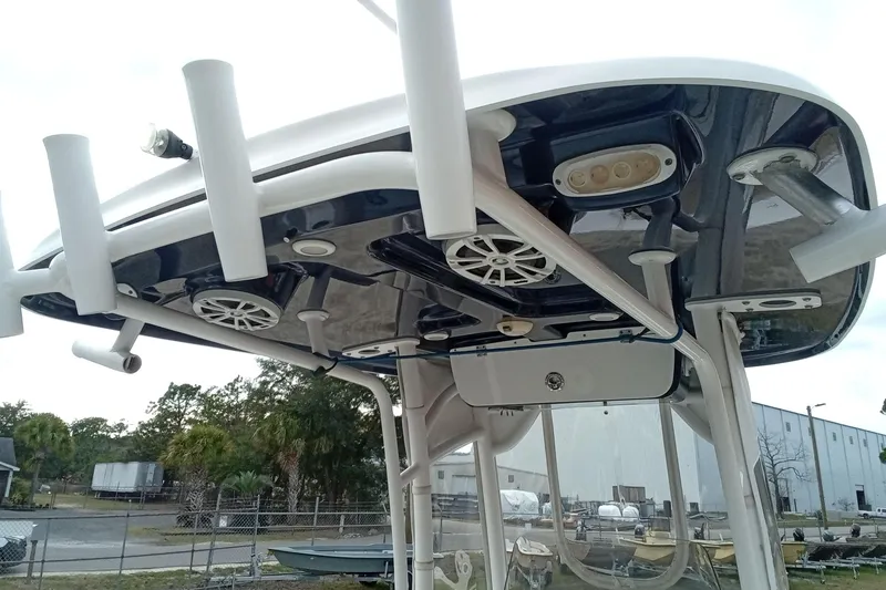 Slide: The Image of 2018 Sportsman Open 232 Center Console boat T-top with rod holders and speakers. - 9