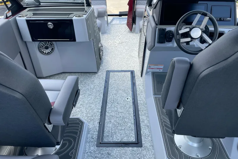 Slide: The Image of Interior of 2025 Revel RS25L boat with modern seating and steering console. - 4