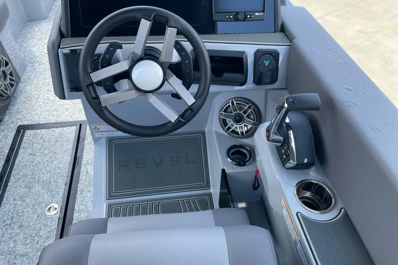 Slide: The Image of 2025 Revel RS25L boat dashboard with steering wheel, controls, and speaker system. - 5