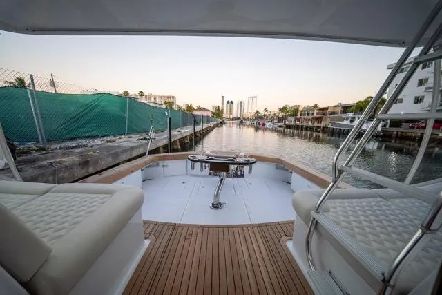 Slide: The Image of 1997 Garlington Convertible yacht with spacious deck, docked in a serene marina setting. - 12