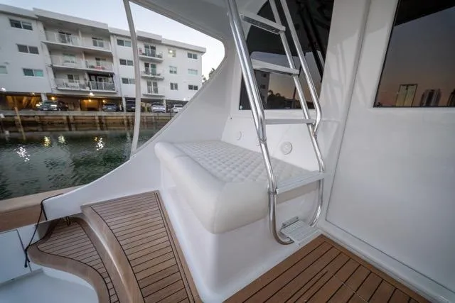Slide: The Image of 1997 Garlington Convertible yacht with teak deck and cushioned seating near marina. - 14