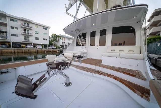 Slide: The Image of 1997 Garlington Convertible yacht with spacious deck and seating, docked near waterfront apartments. - 15