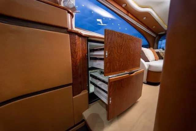 Slide: The Image of Luxurious 1997 Garlington Convertible interior with open wooden cabinets and plush seating. - 17