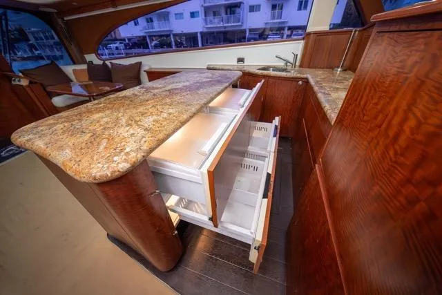 Slide: The Image of Luxurious 1997 Garlington Convertible yacht interior with elegant wood cabinetry and granite countertops. - 18
