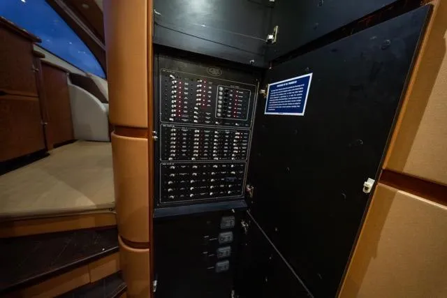 Slide: The Image of Electrical panel inside a 1997 Garlington Convertible yacht, showcasing circuit breakers and controls. - 21