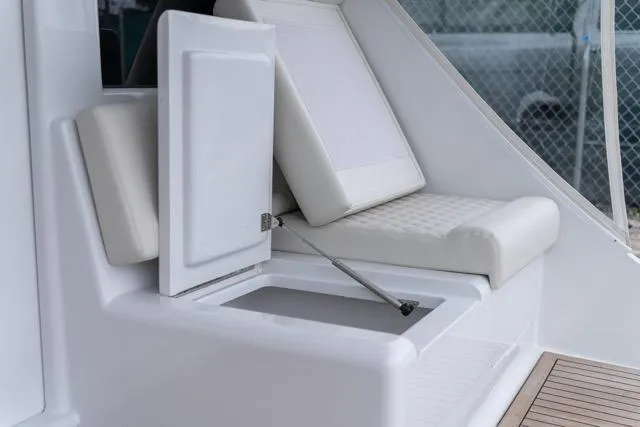 Slide: The Image of 1997 Garlington Convertible boat interior with open storage compartment and cushioned seating. - 24