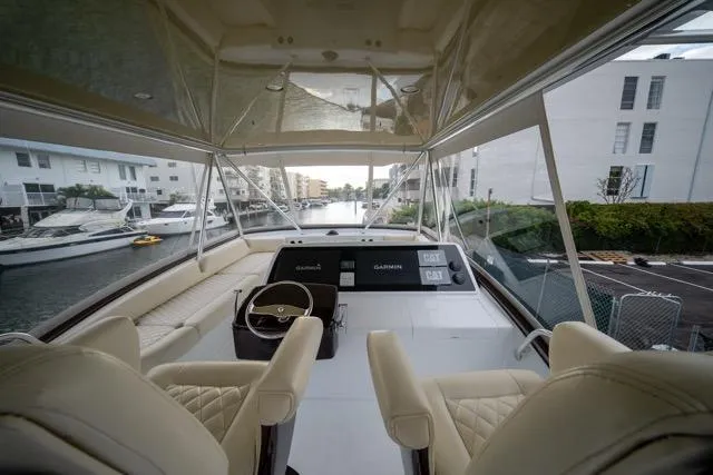 Slide: The Image of Interior view of a 1997 Garlington Convertible yacht with luxurious seating and modern controls. - 27