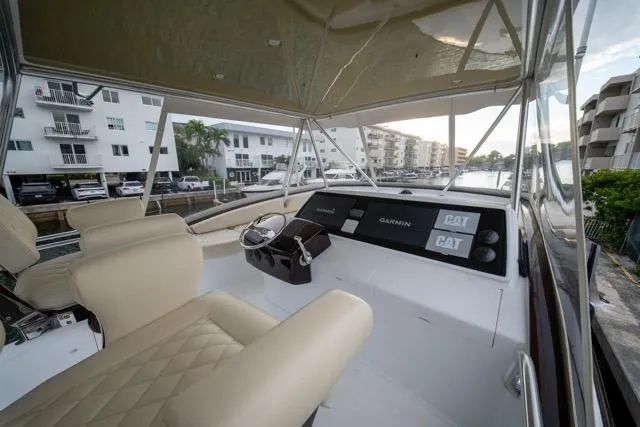 Slide: The Image of 1997 Garlington Convertible yacht interior with beige seating and modern navigation equipment. - 28