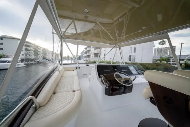 Slide: The Image of 1997 Garlington Convertible yacht interior with helm, seating, and waterfront view. - 29