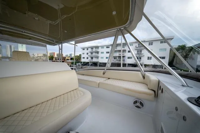 Slide: The Image of Luxurious 1997 Garlington Convertible yacht interior with beige seating and cityscape view. - 30