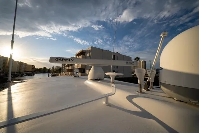 Slide: The Image of Rooftop view of 1997 Garlington Convertible boat with Garmin equipment under a blue sky. - 34