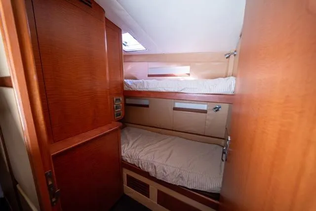 Slide: The Image of 1997 Garlington Convertible yacht interior with cozy bunk beds and wooden finish. - 35