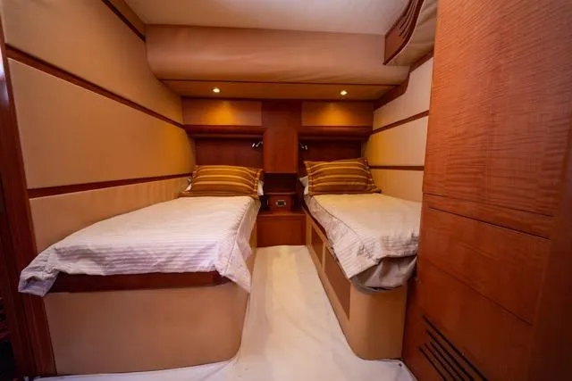 Slide: The Image of Interior of 1997 Garlington Convertible yacht with twin beds and wooden paneling. - 36