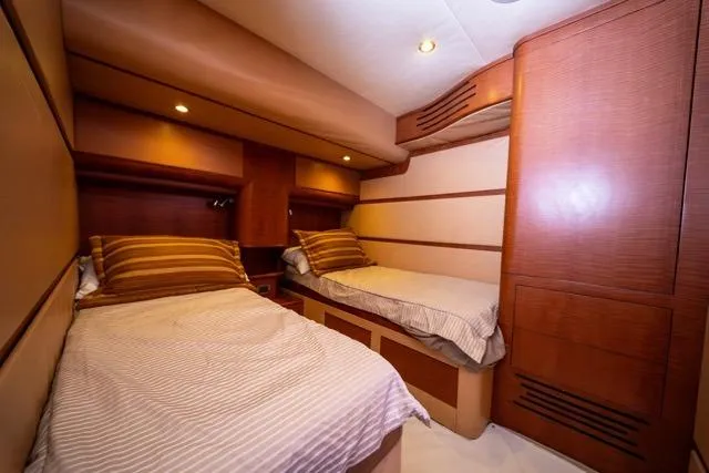 Slide: The Image of Luxurious 1997 Garlington Convertible yacht cabin with twin beds and warm wood accents. - 37