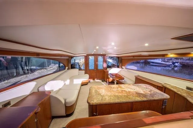 Slide: The Image of Luxurious interior of a 1997 Garlington Convertible yacht with elegant seating and wood finishes. - 42