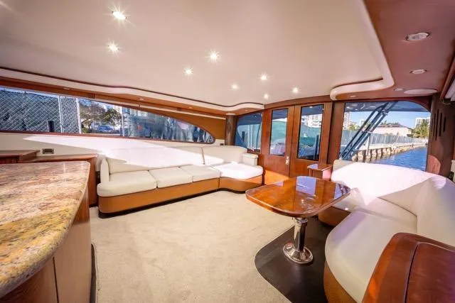 Slide: The Image of Luxurious interior of a 1997 Garlington Convertible yacht with elegant seating and wood finishes. - 48